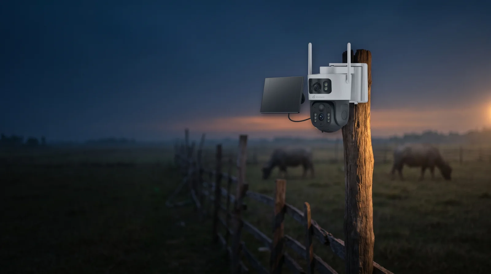 Yoosee 4G solar camera mounted on a fence post above a pasture at dusk